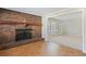 Living area featuring a brick fireplace, hardwood floors, and an open doorway to the carpeted living room at 5812 Dogwood Cir, Austell, GA 30168