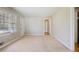 Bright living room featuring neutral walls, plush carpeting, and a large window for ample natural light at 5812 Dogwood Cir, Austell, GA 30168