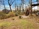 A sloped backyard with mature trees and a walking path at 832 Overlook Trl, Canton, GA 30115