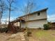 Exterior of home featuring a large back deck, a staircase and some landscaping at 832 Overlook Trl, Canton, GA 30115