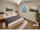 A staged bedroom with large window, decor, ceiling fan, and neutral walls at 832 Overlook Trl, Canton, GA 30115