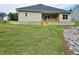 Well-maintained backyard featuring a covered patio and lush green lawn, perfect for outdoor living and entertaining at 112 Scarlett Place Dr, Bowdon, GA 30108