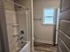 Clean, bright bathroom with shower-tub combo, modern fixtures, and vinyl flooring at 112 Scarlett Place Dr, Bowdon, GA 30108
