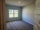 Comfortable bedroom featuring neutral paint, plush carpet, and a large window overlooking the yard at 112 Scarlett Place Dr, Bowdon, GA 30108
