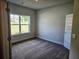 Comfortable bedroom with neutral paint, plush carpet, and a large window overlooking the yard at 112 Scarlett Place Dr, Bowdon, GA 30108