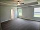 This is the spacious main bedroom that features a tray ceiling, neutral paint, and plush carpet at 112 Scarlett Place Dr, Bowdon, GA 30108