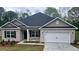 Charming single-story brick home featuring a two-car garage and well-maintained front yard at 116 Scarlett Place Dr, Bowdon, GA 30108