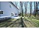 Backyard with lush green lawn, wooded backdrop, and backyard patio at 2076 Greenridge Se Rd, Smyrna, GA 30080