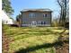 Exterior of home showing backyard with a green, grassy lawn, and stone foundation at 2076 Greenridge Se Rd, Smyrna, GA 30080