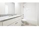 Modern bathroom with granite counters, tile floor, white cabinetry, and combined tub and shower at 2076 Greenridge Se Rd, Smyrna, GA 30080