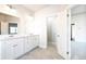 Bright bathroom featuring a double sink vanity, white cabinetry, and tile flooring at 2076 Greenridge Se Rd, Smyrna, GA 30080