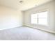 Well-lit bedroom with a large window and carpet flooring at 2076 Greenridge Se Rd, Smyrna, GA 30080