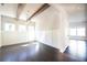 Bright dining room with dark hardwood floors, paneled walls, exposed beams, and modern light fixture at 2076 Greenridge Se Rd, Smyrna, GA 30080