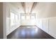 Bright dining room featuring wood-look floors, beamed ceiling, decorative millwork, and a modern pendant light at 2076 Greenridge Se Rd, Smyrna, GA 30080