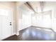 Bright dining room boasts dark wood floors, board and batten wainscoting, a rustic beam ceiling, and modern light fixture at 2076 Greenridge Se Rd, Smyrna, GA 30080