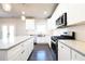 Modern kitchen featuring stainless steel appliances, white cabinets, and a center island at 2076 Greenridge Se Rd, Smyrna, GA 30080