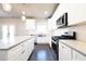 Modern kitchen featuring stainless steel appliances, a center island, white cabinets and stone countertops at 2076 Greenridge Se Rd, Smyrna, GA 30080