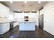 Modern kitchen boasts stainless steel appliances, a center island, and pristine white cabinetry at 2076 Greenridge Se Rd, Smyrna, GA 30080