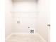 Bright laundry room features tile flooring and a wire rack for storage at 2076 Greenridge Se Rd, Smyrna, GA 30080