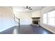 Spacious living room featuring hardwood floors, a stacked stone fireplace, and lots of natural light at 2076 Greenridge Se Rd, Smyrna, GA 30080