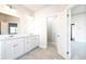 Bright main bathroom featuring double vanity, tiled floors and an open doorway at 2076 Greenridge Se Rd, Smyrna, GA 30080