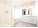 A well-lit main bathroom showcases double sinks, modern fixtures, and a separate shower and soaking tub at 2076 Greenridge Se Rd, Smyrna, GA 30080