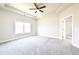 A bright main bedroom featuring tray ceilings, ceiling fan, and ensuite bathroom at 2076 Greenridge Se Rd, Smyrna, GA 30080