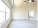 A bright main bedroom featuring tray ceilings, a ceiling fan, and large window at 2076 Greenridge Se Rd, Smyrna, GA 30080