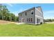 View of the home's rear exterior with spacious, pristine backyard and patio, ideal for relaxation and enjoyment at 333 Willow Cv, Canton, GA 30114