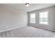 Bedroom with neutral walls, carpeted floors, and natural light from two windows at 333 Willow Cv, Canton, GA 30114