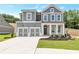 Charming two-story home featuring a two-car garage, stone accents, and a well-manicured front lawn at 333 Willow Cv, Canton, GA 30114