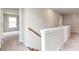 Upstairs hallway with neutral carpet and view into bedroom at 333 Willow Cv, Canton, GA 30114