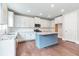 Modern kitchen featuring white cabinetry, granite countertops, a blue island, and stainless-steel appliances at 333 Willow Cv, Canton, GA 30114