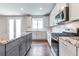 Bright kitchen featuring granite countertops, stainless steel appliances, and white cabinets at 333 Willow Cv, Canton, GA 30114