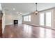 Open living room featuring hardwood floors, a cozy fireplace, and elegant lighting, creating a warm atmosphere at 333 Willow Cv, Canton, GA 30114
