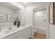 Bright bathroom with double sinks, a large mirror, and a combined shower and tub at 5523 Rosehall Pl, Atlanta, GA 30349