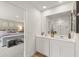 Bathroom featuring double sink vanity with white cabinets and a large mirror over the countertop at 5523 Rosehall Pl, Atlanta, GA 30349