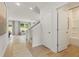 Bright entryway featuring wood-look floors, stairs to the second level, and a door to the bathroom at 5523 Rosehall Pl, Atlanta, GA 30349