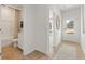 Inviting entryway with wood-look flooring and natural light, leading to a powder room and the front door at 5523 Rosehall Pl, Atlanta, GA 30349