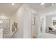 Bright hallway with neutral walls, white trim, artwork, and access to other areas of the home at 5523 Rosehall Pl, Atlanta, GA 30349