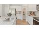 Bright kitchen featuring stainless steel appliances, granite counters, a pantry, and light hardwood flooring at 5523 Rosehall Pl, Atlanta, GA 30349