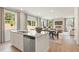 Open-concept kitchen features granite countertops, a stainless steel dishwasher, and connects to the dining and living spaces at 5523 Rosehall Pl, Atlanta, GA 30349
