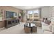 Cozy living room features a comfortable sectional sofa, entertainment center, and scenic outdoor views at 5523 Rosehall Pl, Atlanta, GA 30349