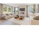 Cozy living room with ample natural light and a modern fireplace with decorative mantle at 5523 Rosehall Pl, Atlanta, GA 30349