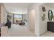 Bright living room with neutral decor, plush carpeting and a view of the outdoors through a large window at 5523 Rosehall Pl, Atlanta, GA 30349