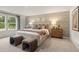 This main bedroom has a large bed, coordinated linens, and dual nightstands with lamps at 5523 Rosehall Pl, Atlanta, GA 30349