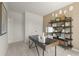 Cozy office featuring a large dark desk, modern shelving, and neutral-toned decor for a productive workspace at 5523 Rosehall Pl, Atlanta, GA 30349