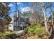 Exterior view of the home's backyard, complete with a deck, patio, and lush landscaping at 1129 Gavinwood Pl, Decatur, GA 30033