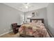 This bedroom features a sitting chair, a desk, grey walls, a fan and carpeted floors at 1129 Gavinwood Pl, Decatur, GA 30033