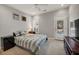 The bedroom features grey walls, carpeted floors, a television, shutters, and a striped bed spread at 1129 Gavinwood Pl, Decatur, GA 30033